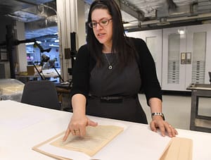 Curator Kyra Schuster goes over a manuscript of Primo Levi's famous holocaust memoir, "Survival in Auschwitz," which was donated to the U.S. Holocaust Memorial Museum in Washington. (Linda Davidson/The Washington Post)