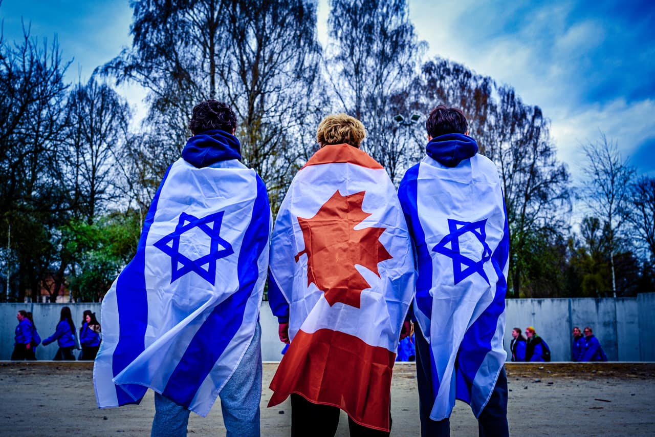 Three participants draped in Israeli and Canadian flags